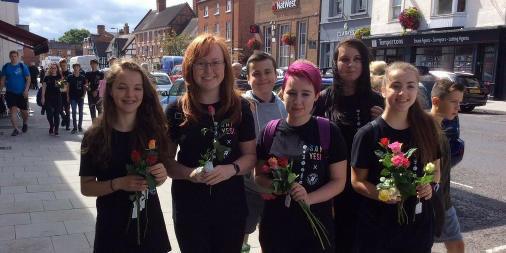 Young women giving flowers